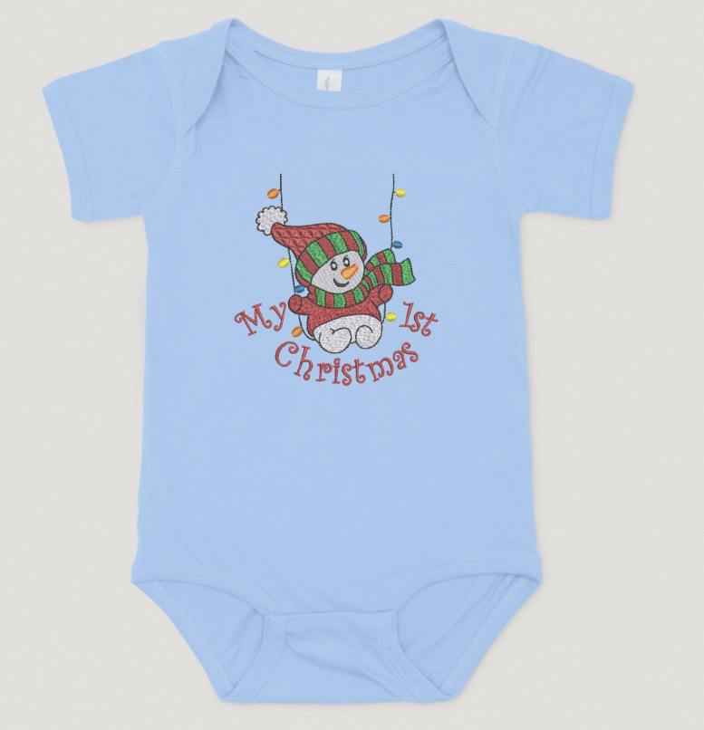 Light blue baby onesie with a snowman design and text on a light gray background