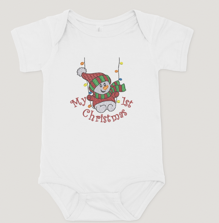 White baby onesie with a snowman design and 'My 1st Christmas' text on a light gray background